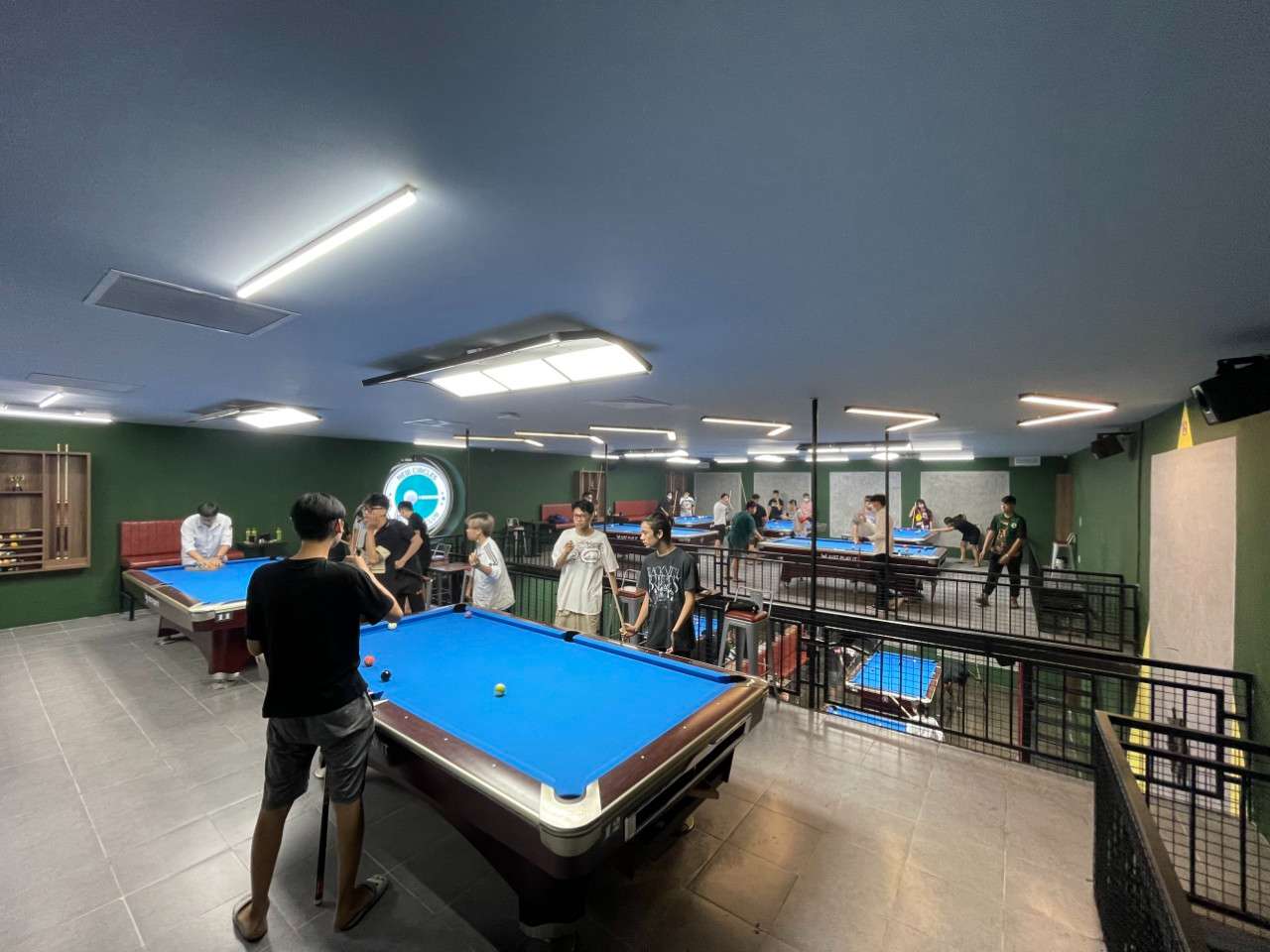 A group of people playing pool

Description automatically generated with medium confidence